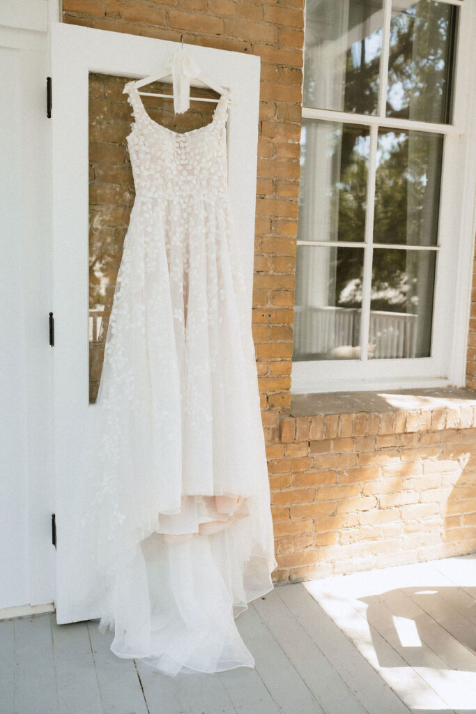 Wedding dress hanging in a suite at Kimpton Santo Hotel during a San Antonio wedding