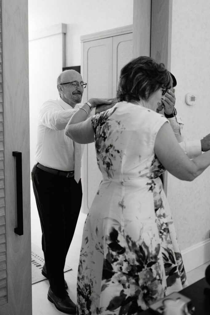Groom blindfolded in a Kimpton Santo Hotel room for a private first look with the bride