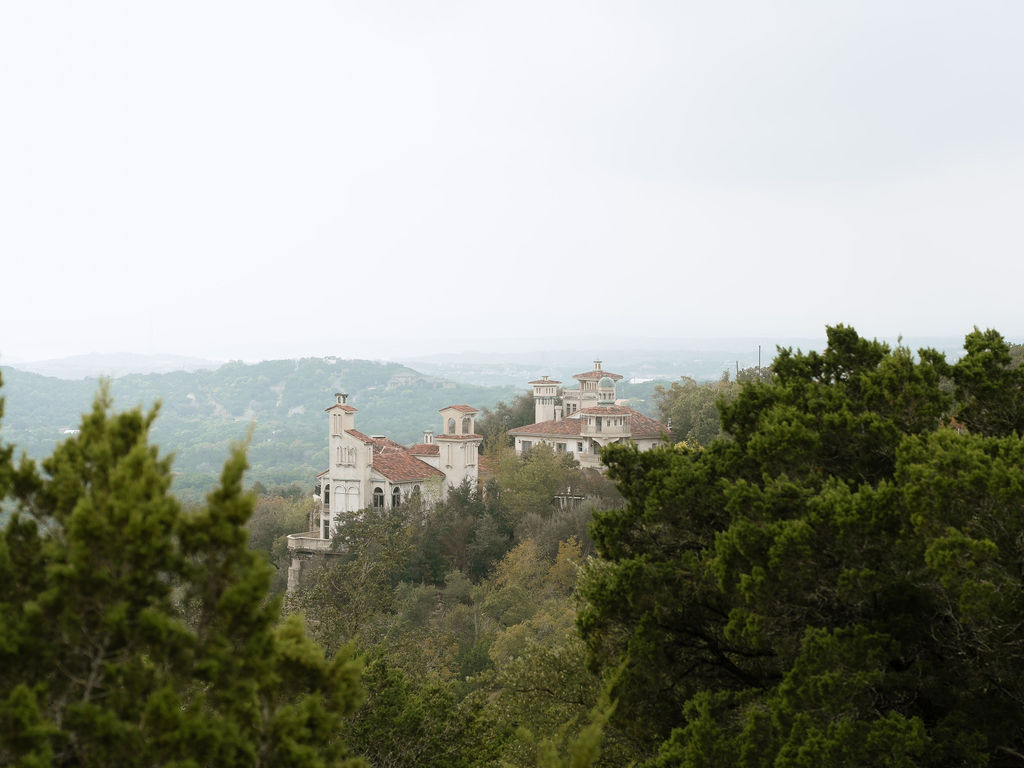 Villa Antonia wedding venue exterior with Mediterranean stone arches and Hill Country views in Jonestown Texas
