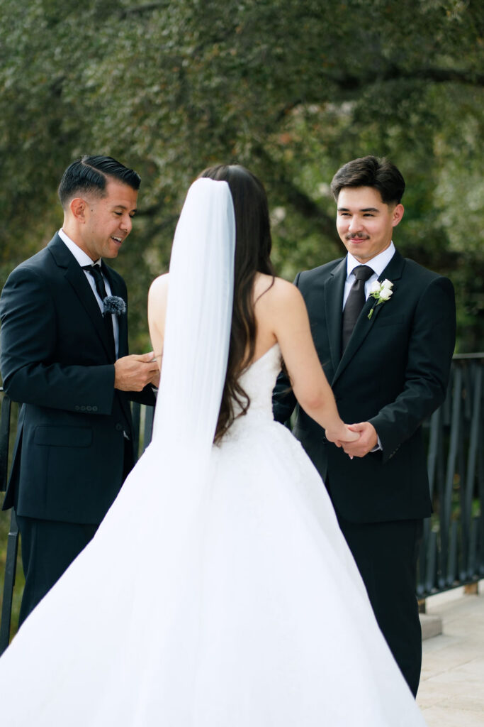 Bride and groom sharing vows surrounded by family at intimate Villa Antonia wedding in Jonestown Texas