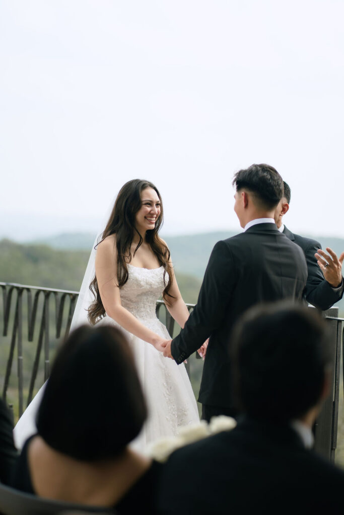 Bride and groom sharing vows surrounded by family at intimate Villa Antonia wedding in Jonestown Texas