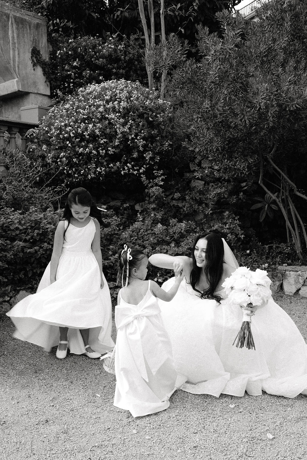 Flower girls in white dresses alongside wedding party in black at Villa Antonia Hill Country wedding