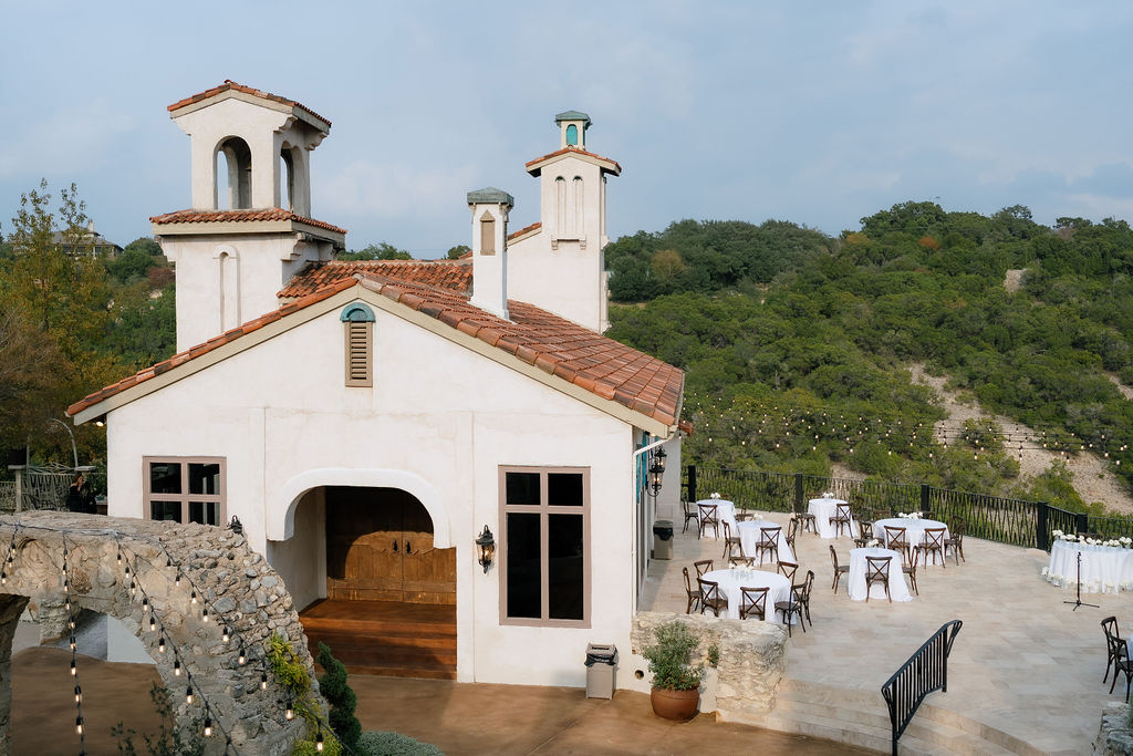 Villa Antonia wedding venue exterior with Mediterranean stone arches and Hill Country views in Jonestown Texas