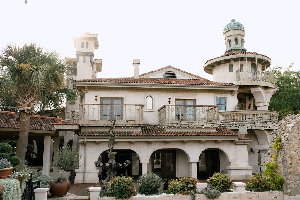 Villa Antonia wedding venue exterior with Mediterranean stone arches and Hill Country views in Jonestown Texas