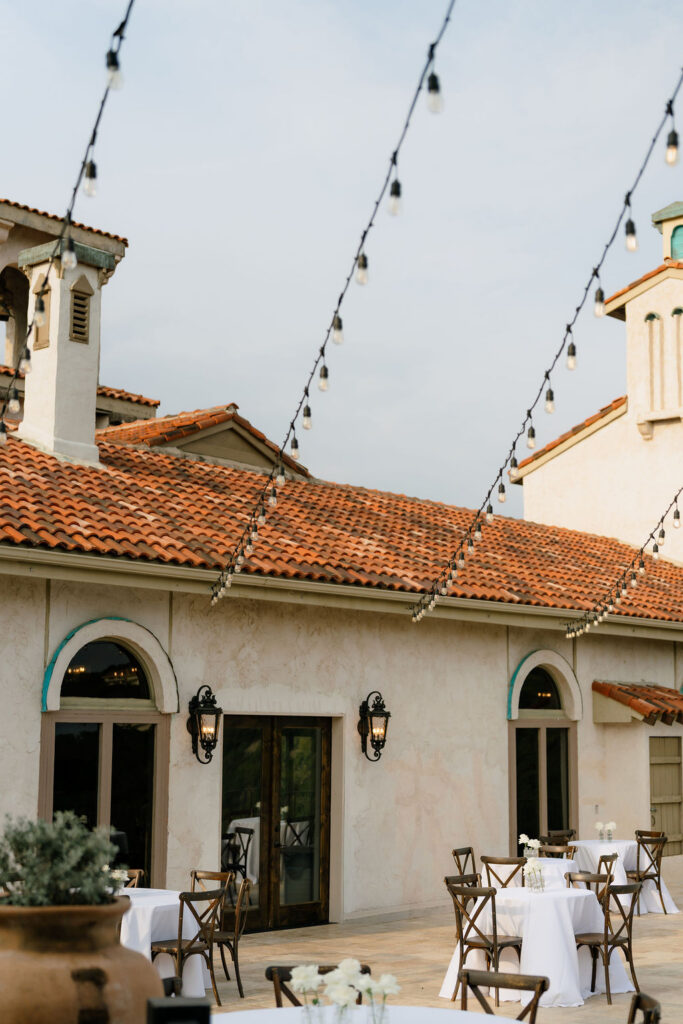 Villa Antonia wedding venue exterior with Mediterranean stone arches and Hill Country views in Jonestown Texas