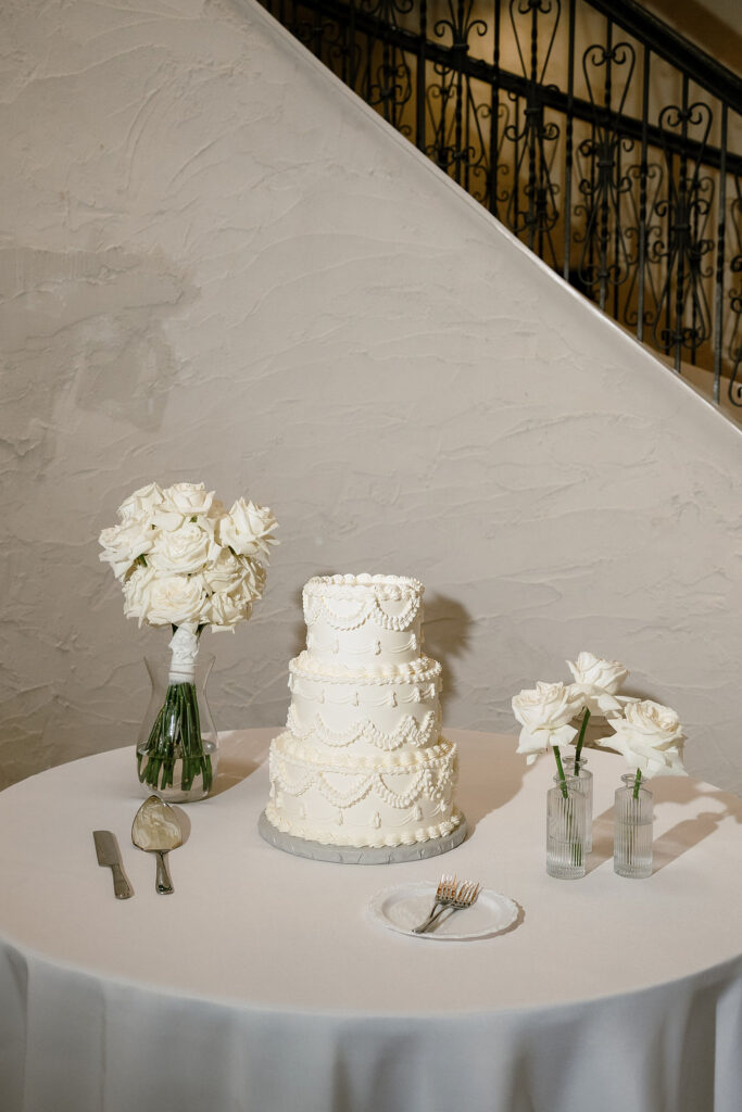 Minimalist white wedding cake at Villa Antonia wedding reception in Jonestown Texas