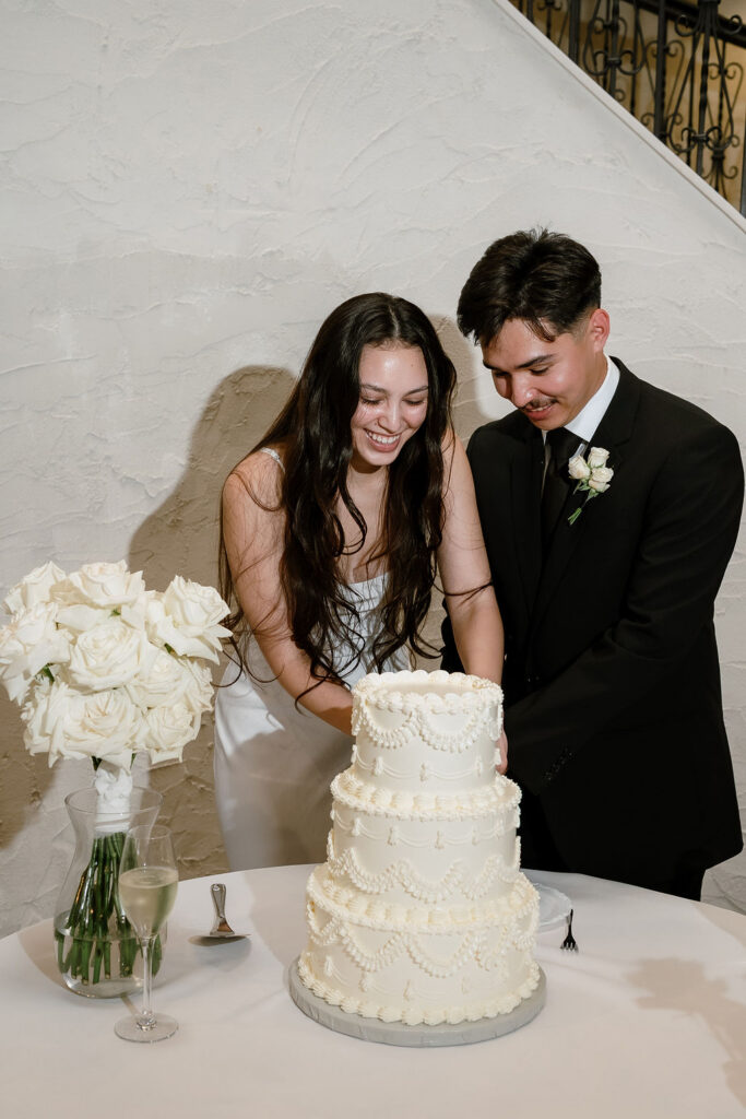 Minimalist white wedding cake at Villa Antonia wedding reception in Jonestown Texas