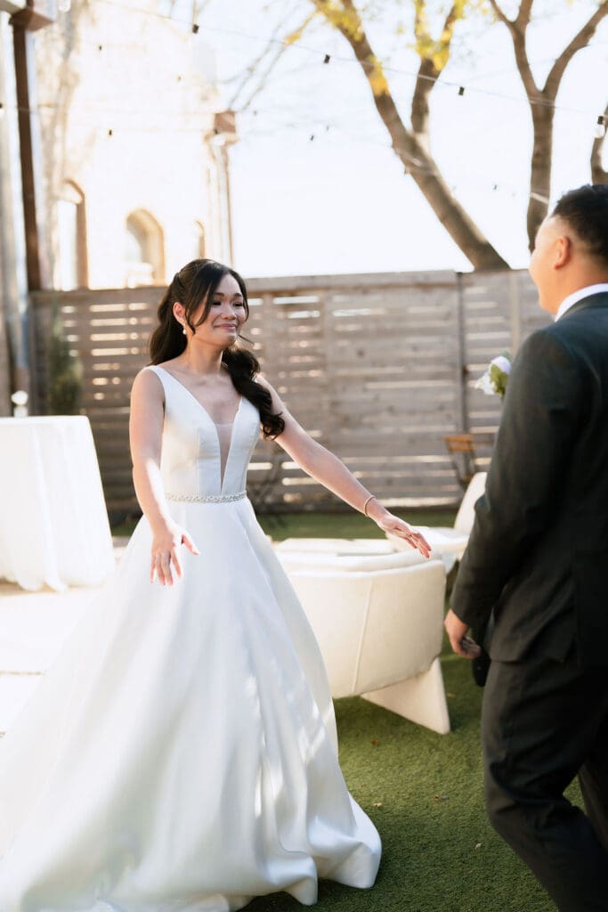 Romantic first look between bride and groom at One Eleven East wedding venue in Hutto Texas, captured by Andrea Jang Photography