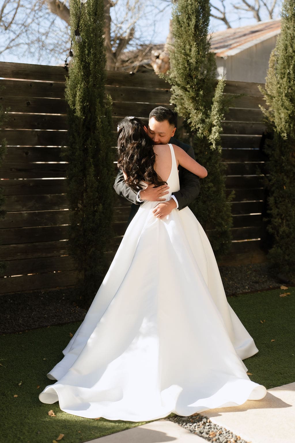 Bride and groom share an emotional first look at One Eleven East in Hutto Texas during their winter wedding, photographed by San Antonio wedding photographer Andrea Jang