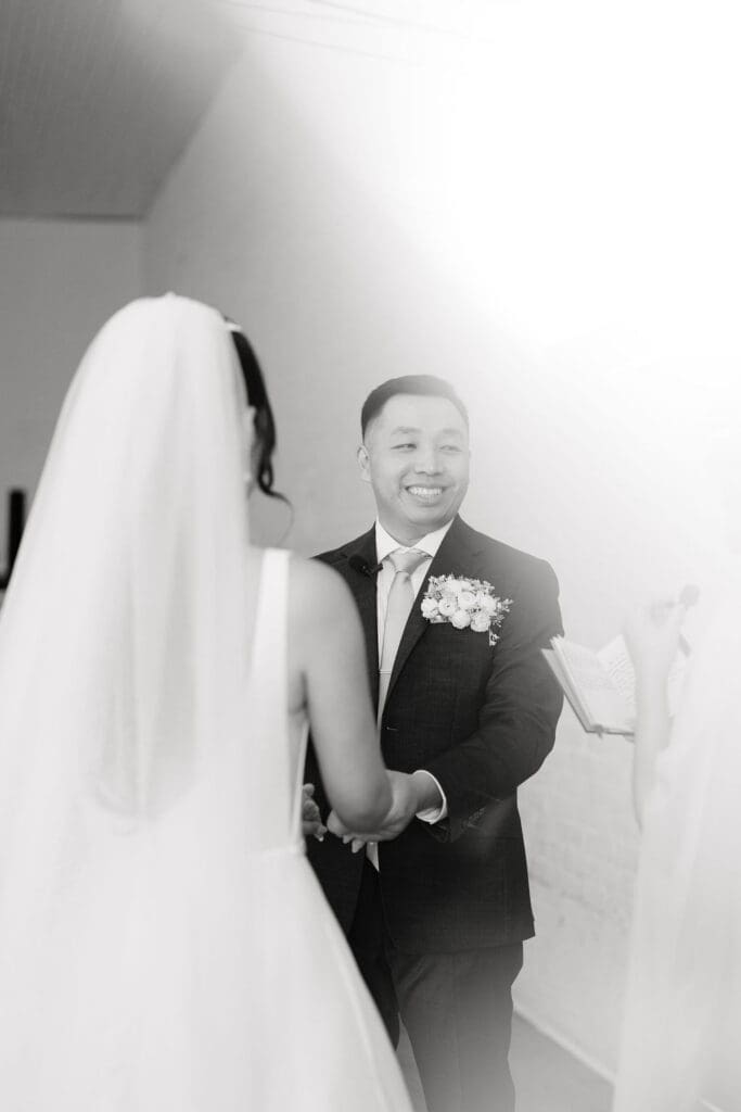 Groom smiling on his wedding day at One Eleven East in Hutto Texas, portrait captured by Andrea Jang Photography