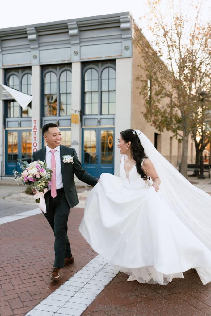 Bride and groom walking hand in hand at One Eleven East in Hutto Texas, winter wedding portrait by Andrea Jang Photography