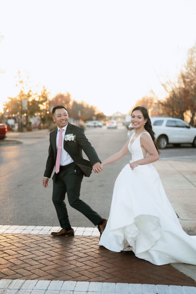 Bride and groom walking hand in hand at One Eleven East in Hutto Texas, winter wedding portrait by Andrea Jang Photography