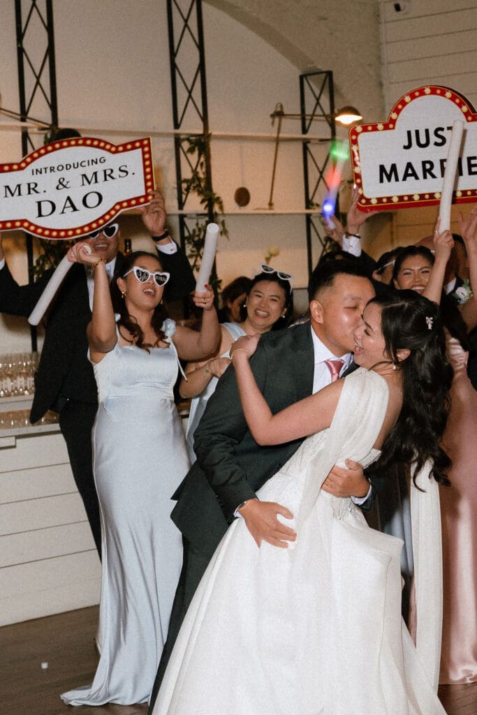 Bride and groom celebrating at their winter wedding reception at One Eleven East in Hutto Texas, photography by Andrea Jang