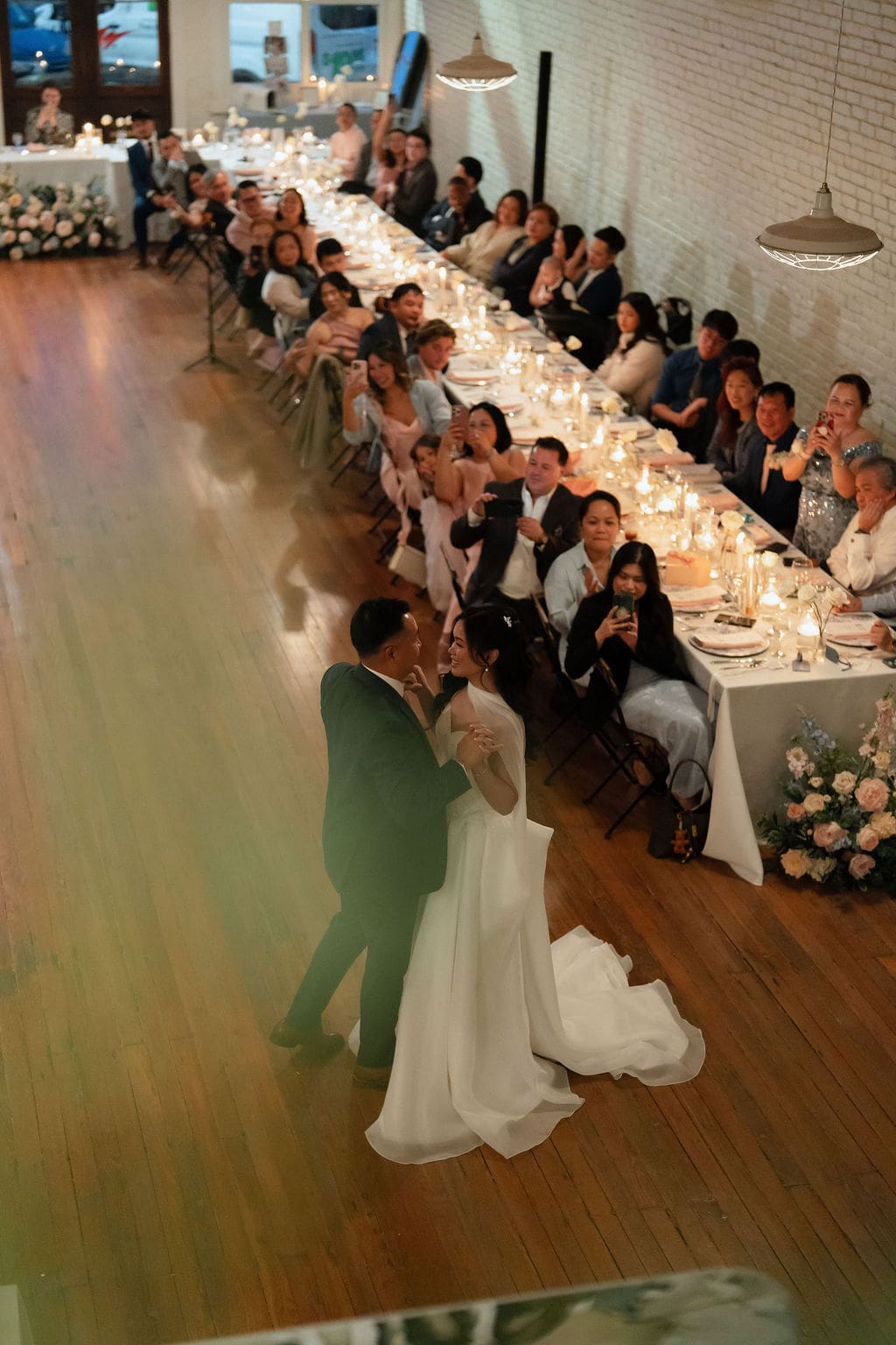 Winter wedding reception at One Eleven East in Hutto Texas filled with warm florals and elegant decor, captured by San Antonio wedding photographer Andrea Jang