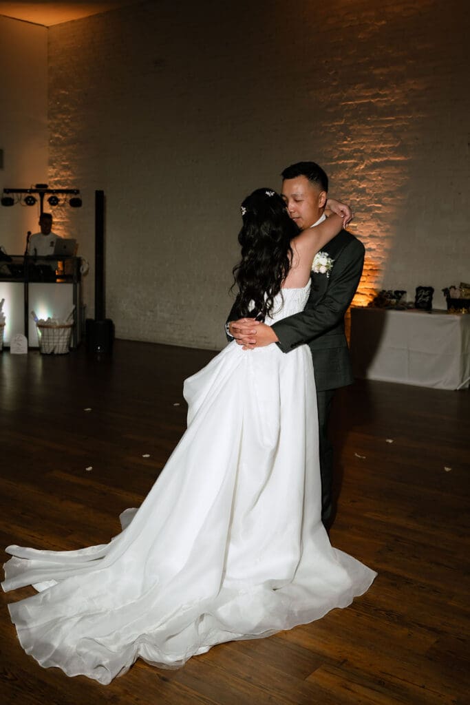 Romantic solo last dance between newlyweds at One Eleven East in Hutto Texas, intimate winter wedding moment by Andrea Jang