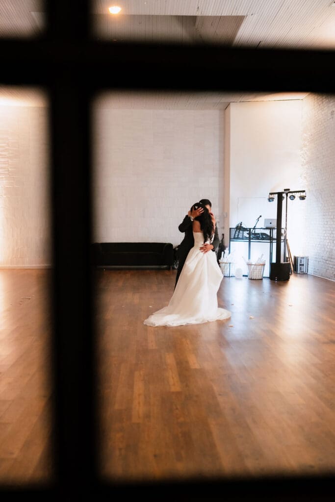 Bride and groom share a private last dance together as husband and wife at their One Eleven East winter wedding in Hutto Texas, photographed by Andrea Jang Photography