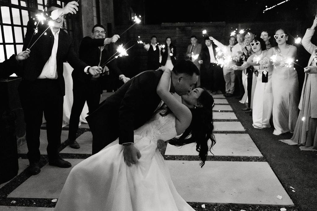 Newlyweds sharing a kiss during their winter wedding portraits at One Eleven East in Hutto Texas, photography by Andrea Jang