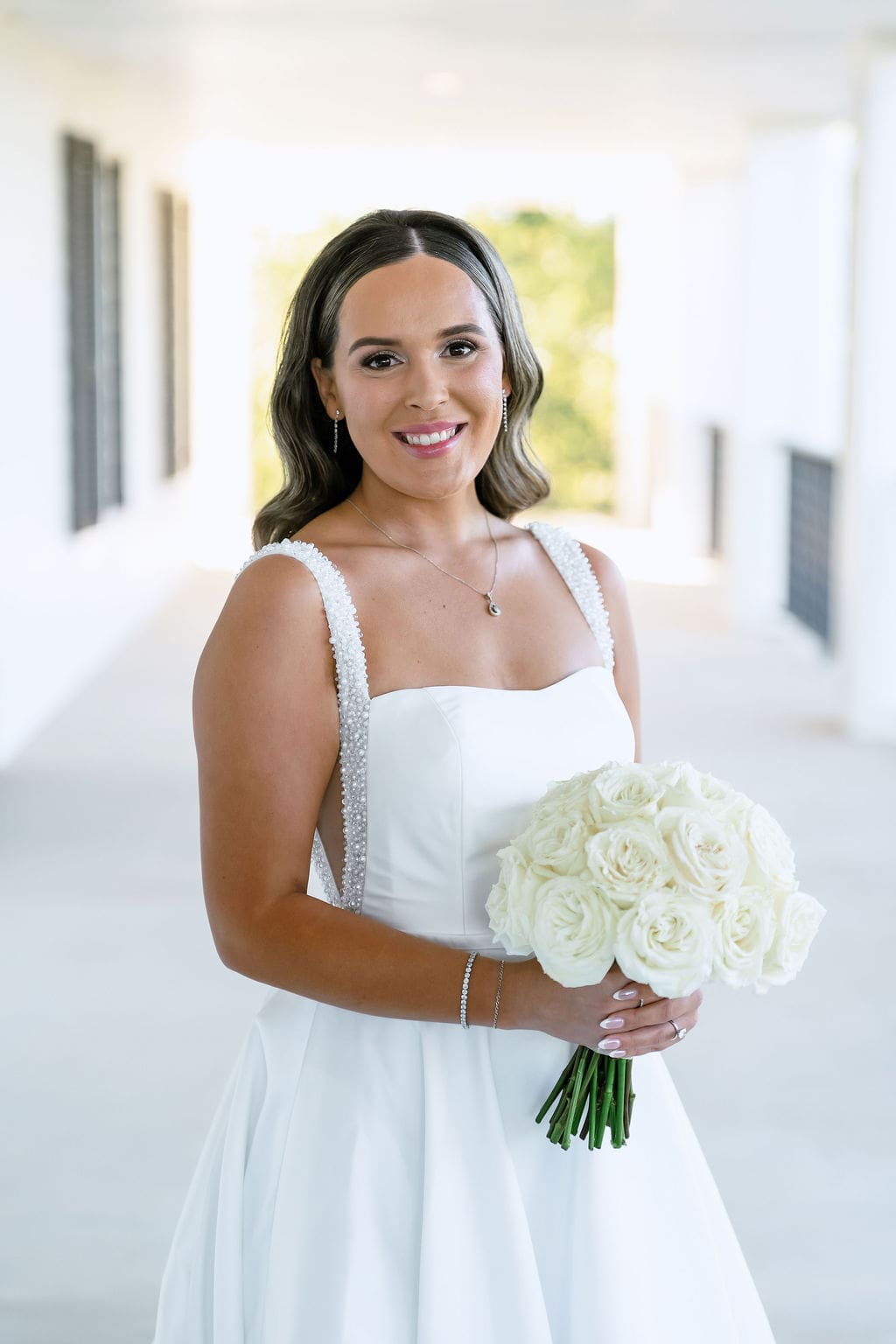 Bride in wedding gown holding bouquet at Kendall Point Boerne TX
