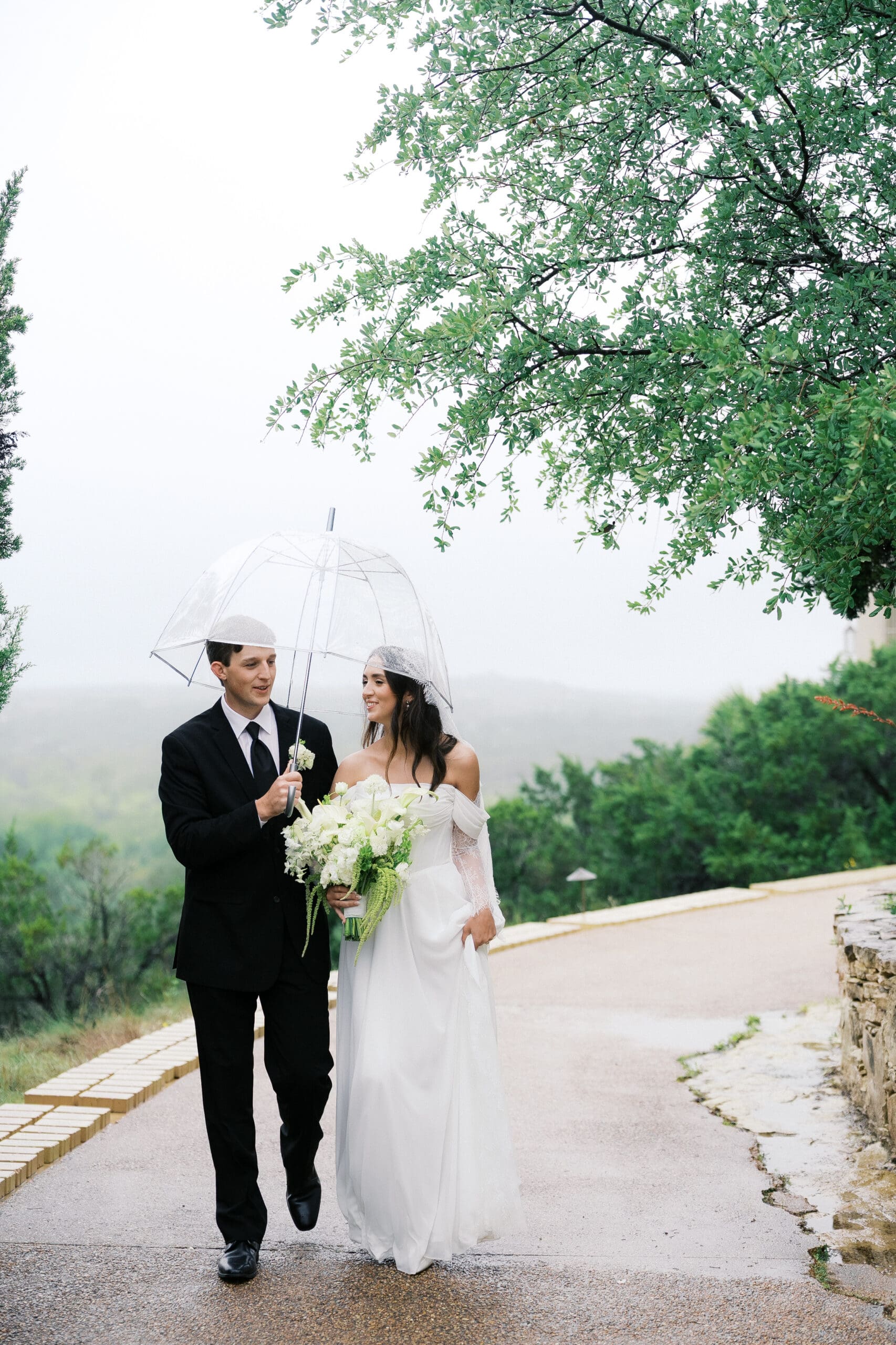 Bride and groom romantic rainy day wedding portraits at Chapel Dulcinea Austin Texas