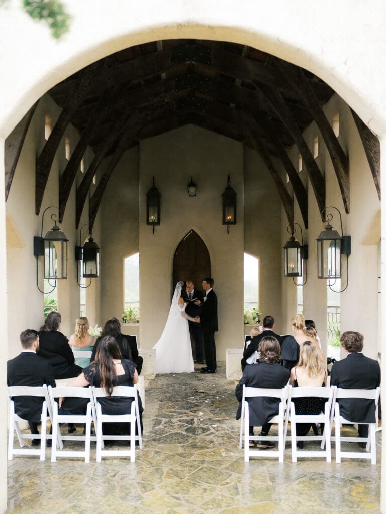 Bride and groom exchanging vows at Chapel Dulcinea in the rain Austin Texas spring wedding