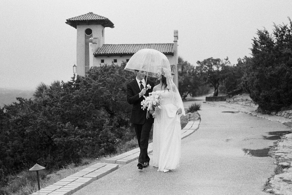 Bride and groom romantic rainy day wedding portraits at Chapel Dulcinea Austin Texas