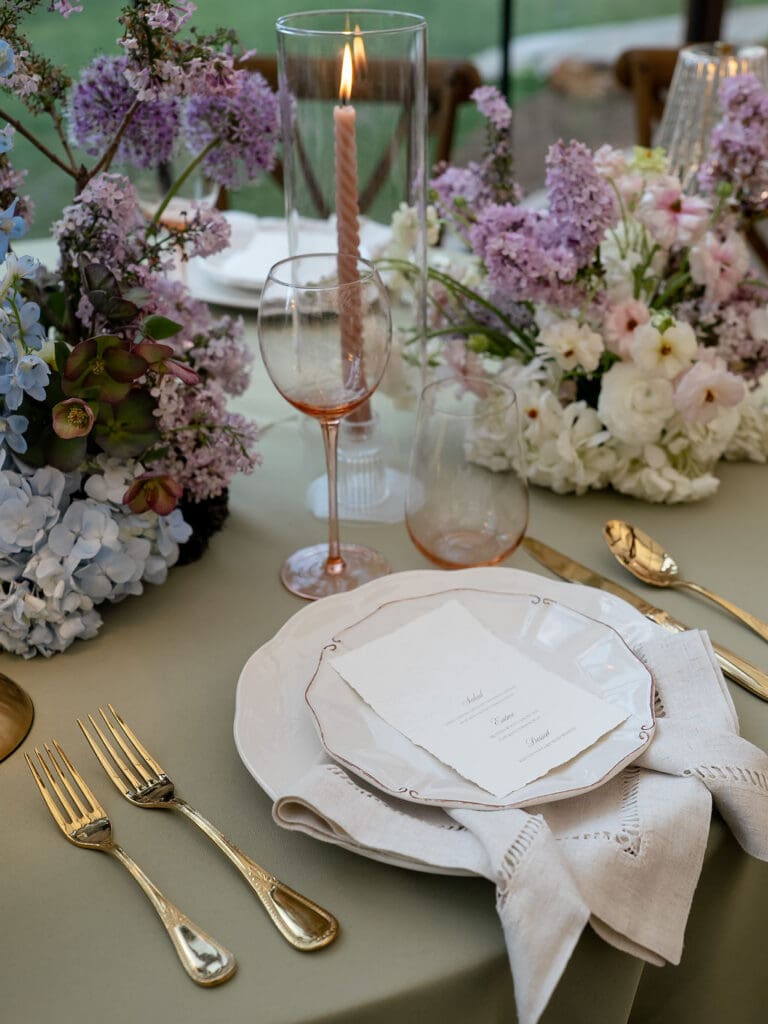 Monet inspired wedding reception tablescape with sage green velvet linens, impressionist floral centerpieces, and peach taper candles at Wild Roots Lockhart Texas, photographed by Austin wedding photographer Andrea Jang