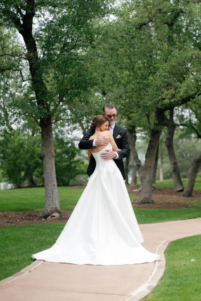 Bride sharing a first look with her father before Canyonwood Ridge wedding ceremony