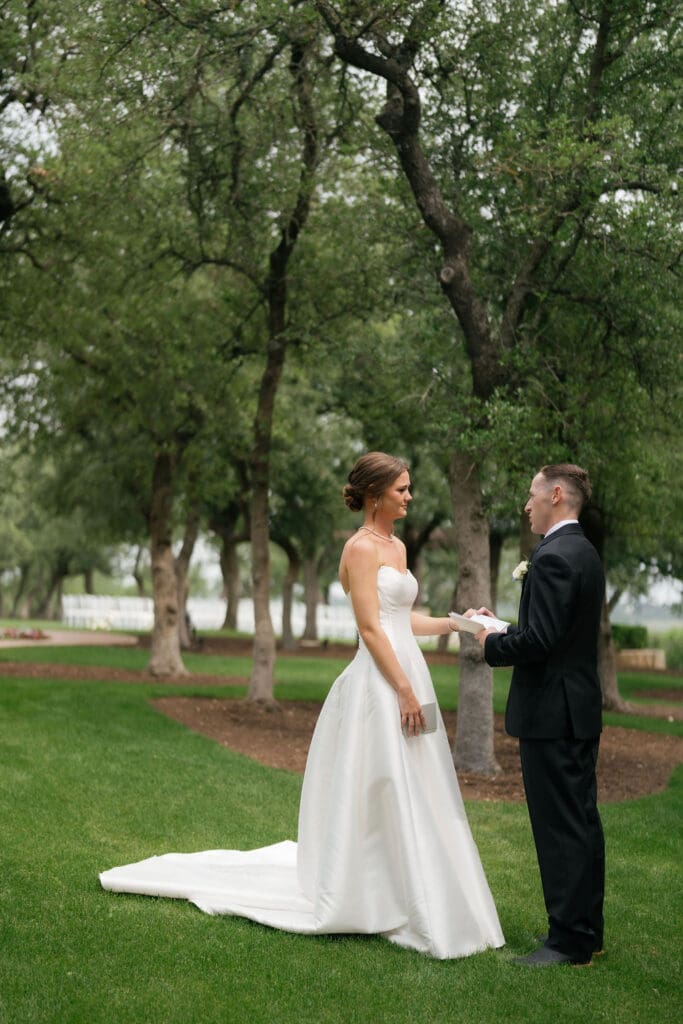 Bride and groom reading private vows to each other before their Canyonwood Ridge wedding