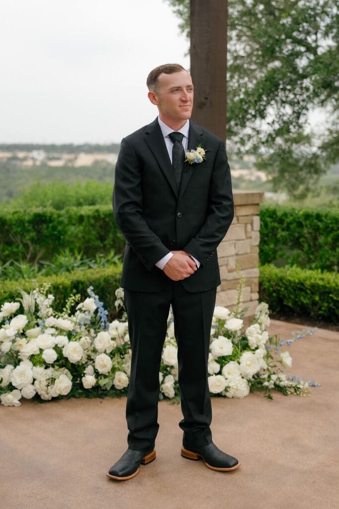 Groom smiling as his bride walks down the aisle at Canyonwood Ridge