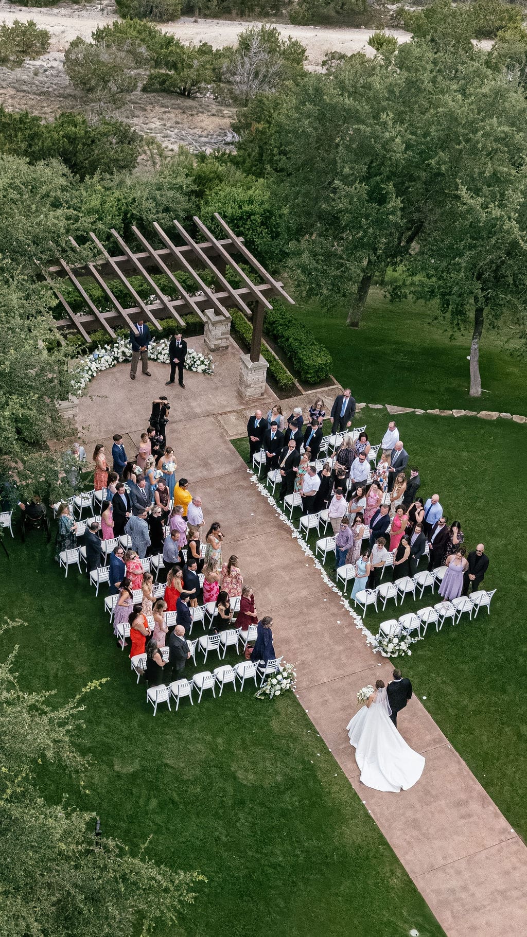 Bride walking down the aisle at her spring Canyonwood Ridge wedding