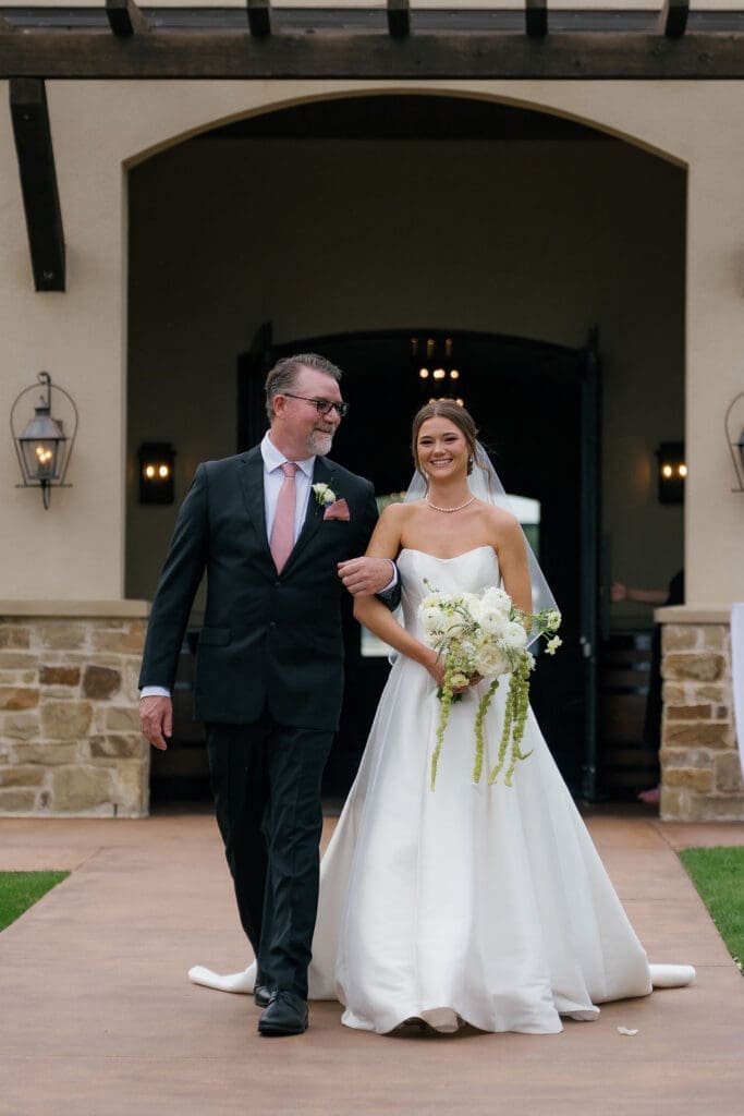 Bride walking down the aisle at her spring Canyonwood Ridge wedding"