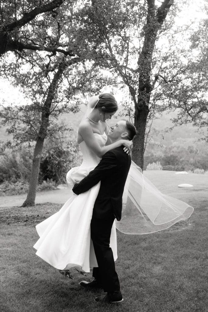 Romantic portrait of bride and groom with Canyonwood Ridge hills in the background