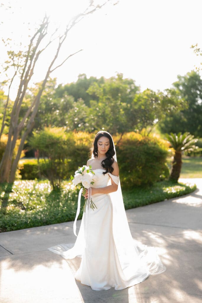 Bride in a white wedding gown standing at Landa Library in San Antonio Texas