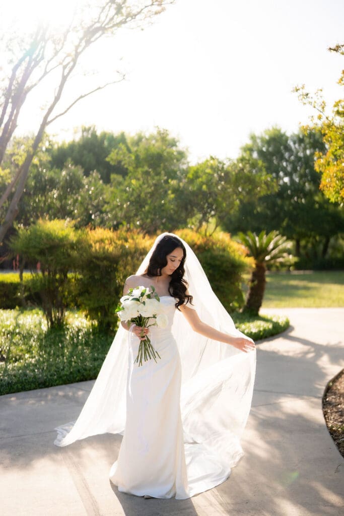 Bride in a white wedding gown standing at Landa Library in San Antonio Texas