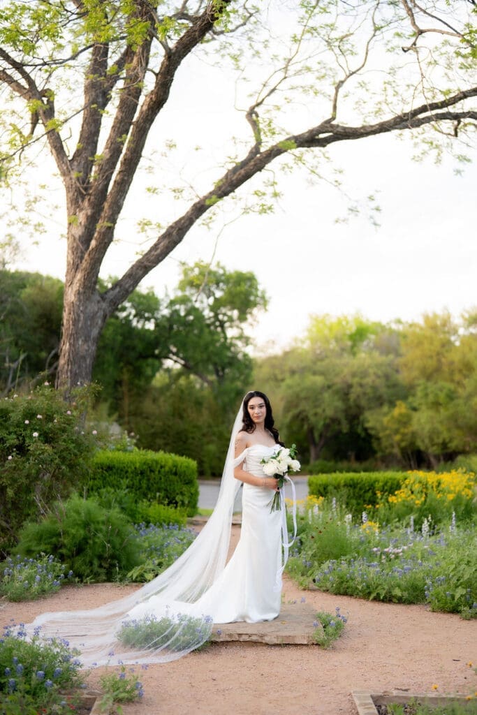 Bride in a white wedding gown standing at Landa Library in San Antonio Texas