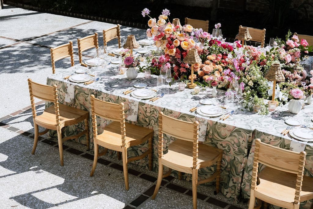 Outdoor wedding tablescape with botanical linen and colorful florals at The Gadsden House Charleston South Carolina
