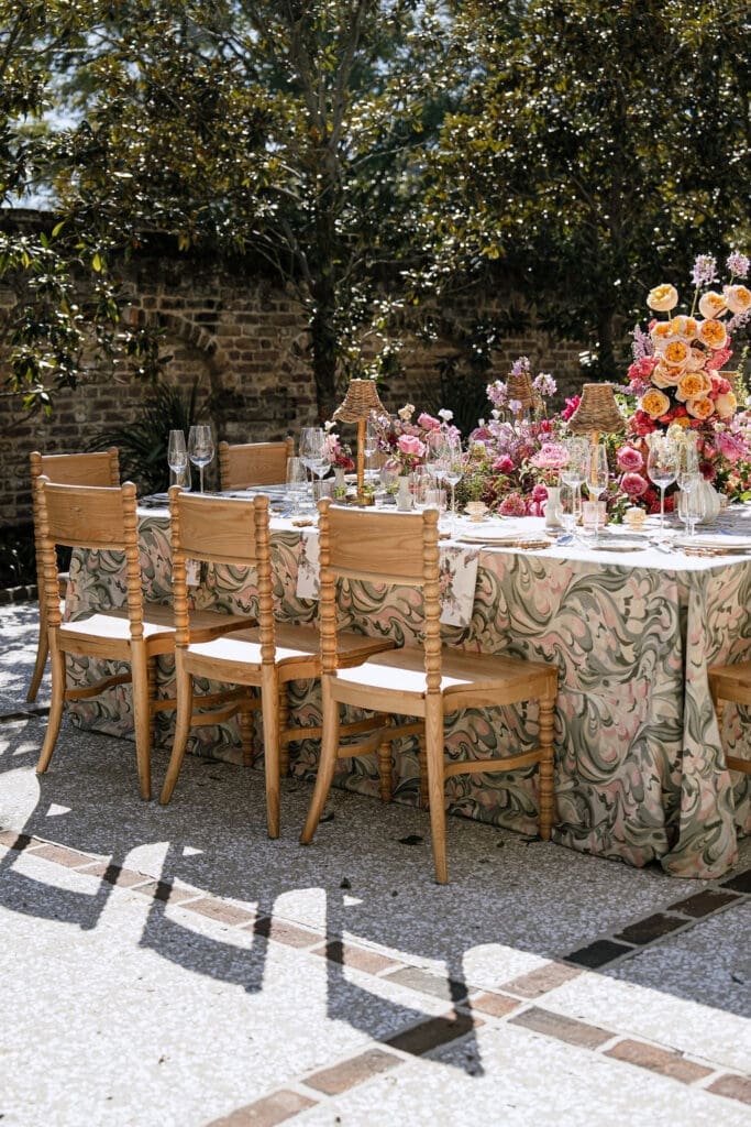 Outdoor wedding tablescape with botanical linen and colorful florals at The Gadsden House Charleston South Carolina