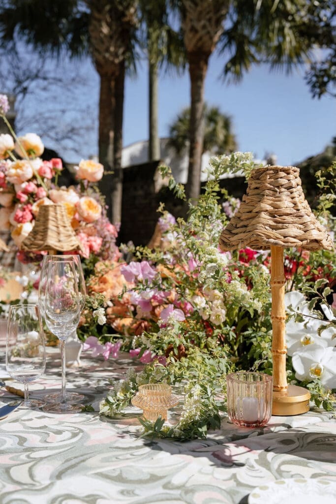 Outdoor wedding tablescape with botanical linen and colorful florals at The Gadsden House Charleston South Carolina