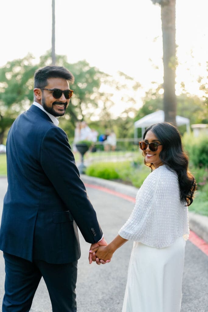 couple walking hand in hand along a garden path San Antonio Texas