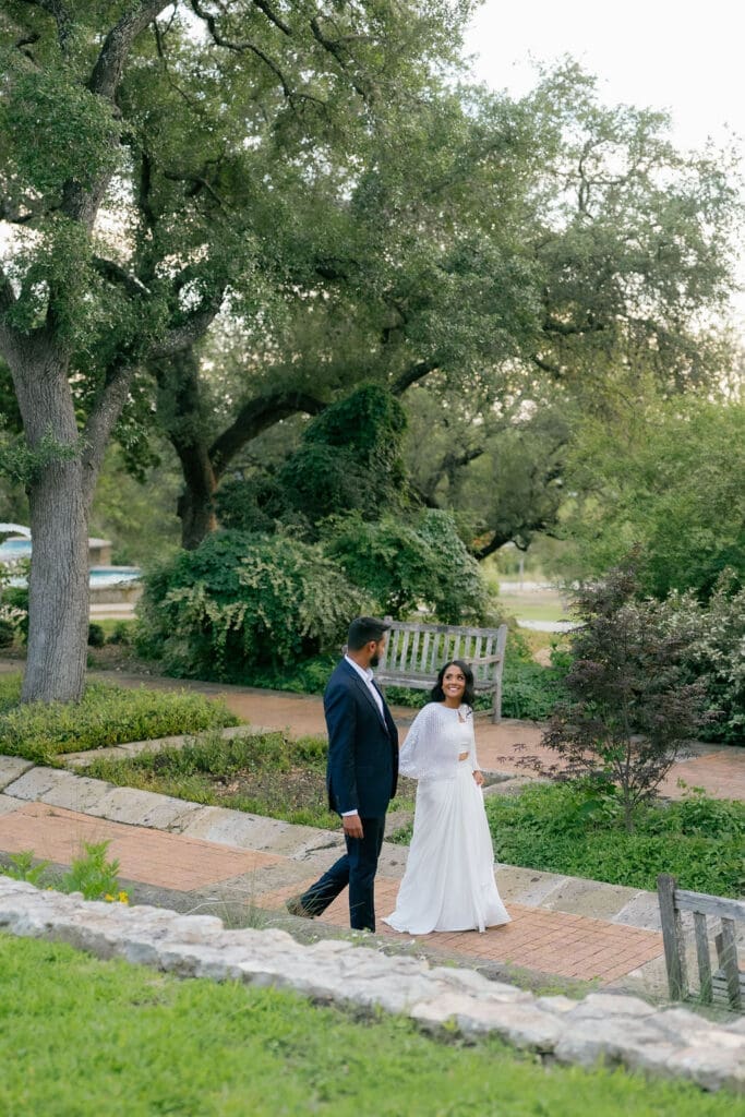 couple walking hand in hand along a garden path San Antonio Texas