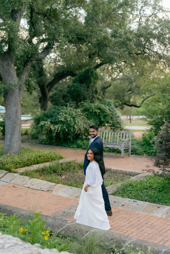 couple walking hand in hand along a garden path San Antonio Texas