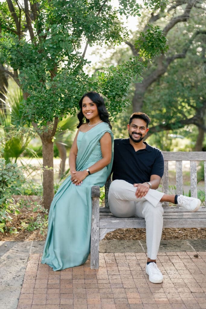 couple sharing a quiet moment on a garden bench surrounded by greenery