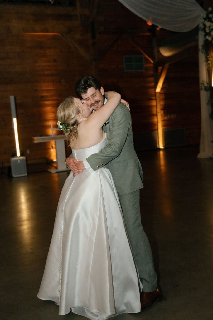 Newlyweds slow dancing at the end of their Addison Grove wedding reception