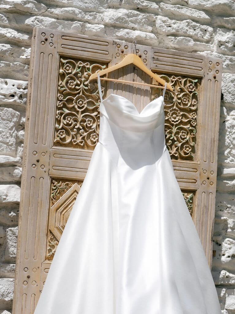 Dana's wedding dress hanging in the window on her wedding morning