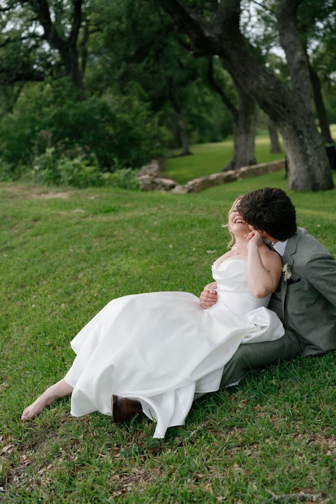 Bride and groom laughing together during golden hour wedding portraits
