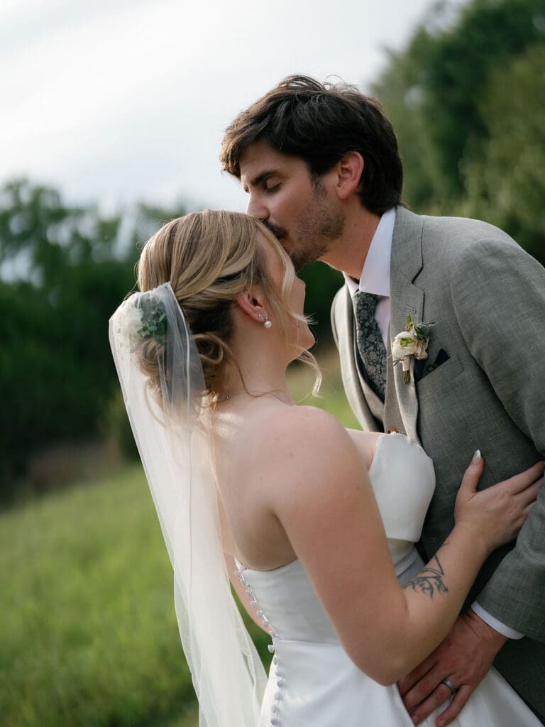 Bride leaning in for a kiss with her new husband