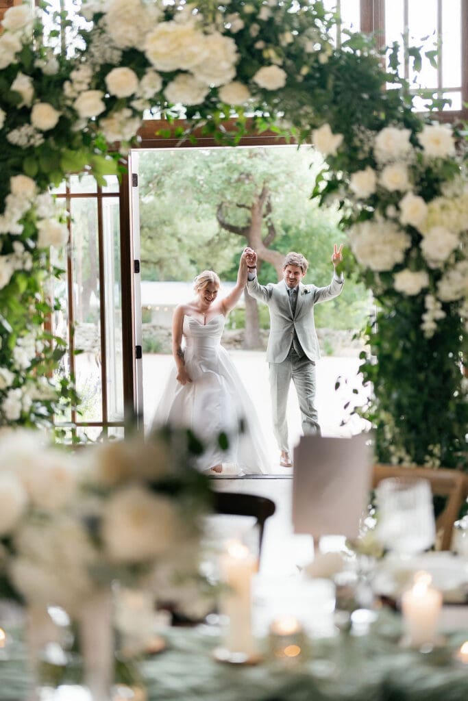Dana and Jack entering their reception to cheers from friends and family