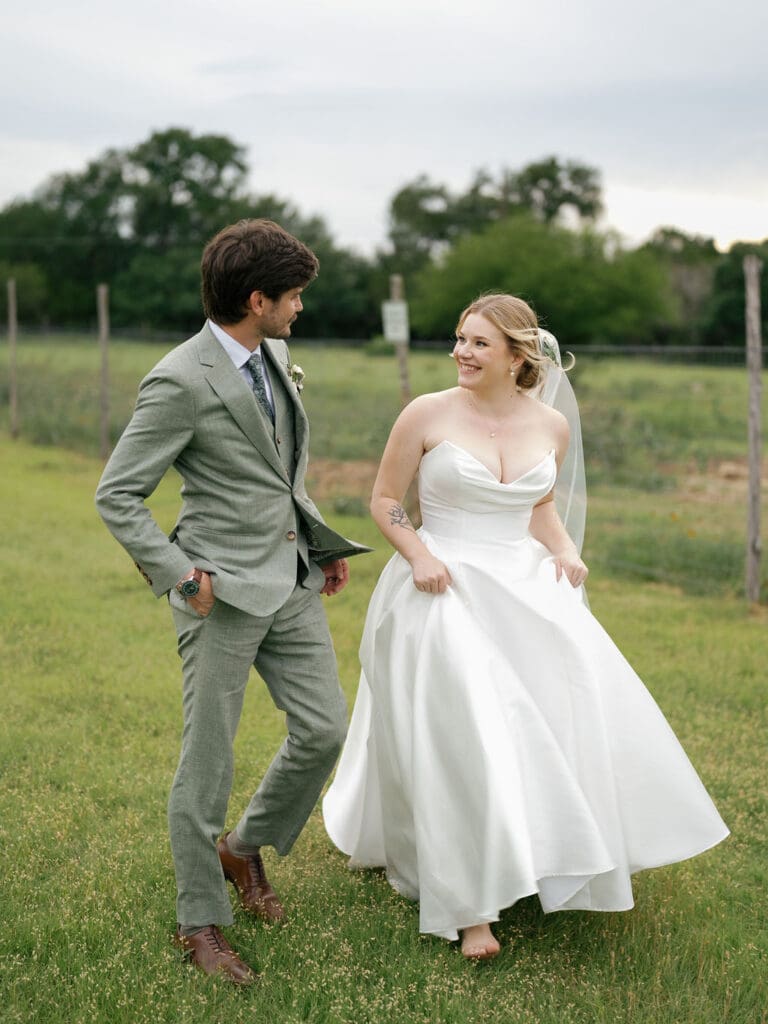 Barefoot bride walking the grounds on her Addison Grove wedding day