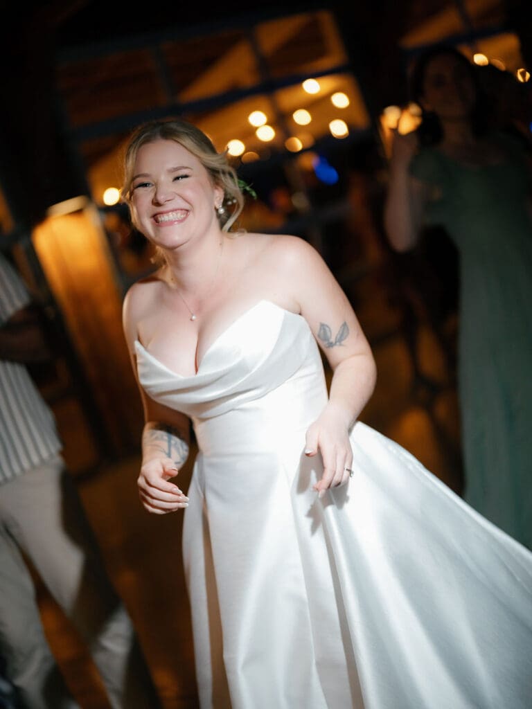 Candid moment of Dana smiling to herself on her wedding day
