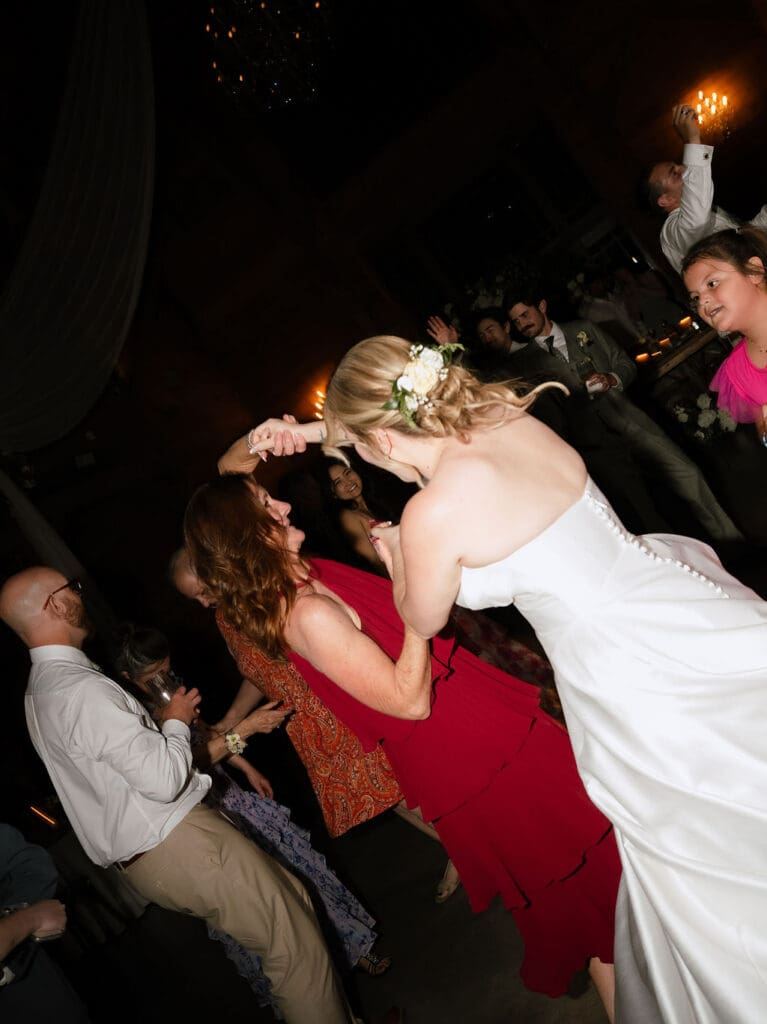 Dana and Jack dancing with guests on the wedding dance floor